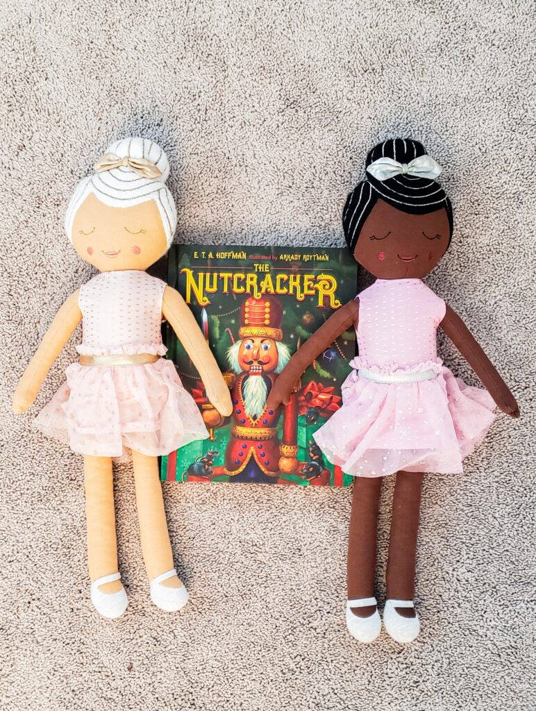 picture of 2 ballerina dolls from Target with a book of The Nutcracker