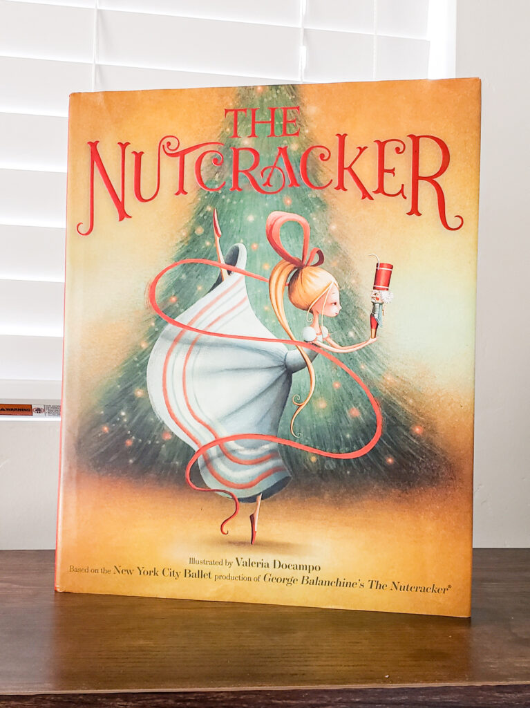 picture of The Nutcracker book by New York City Ballet on a book shelf 