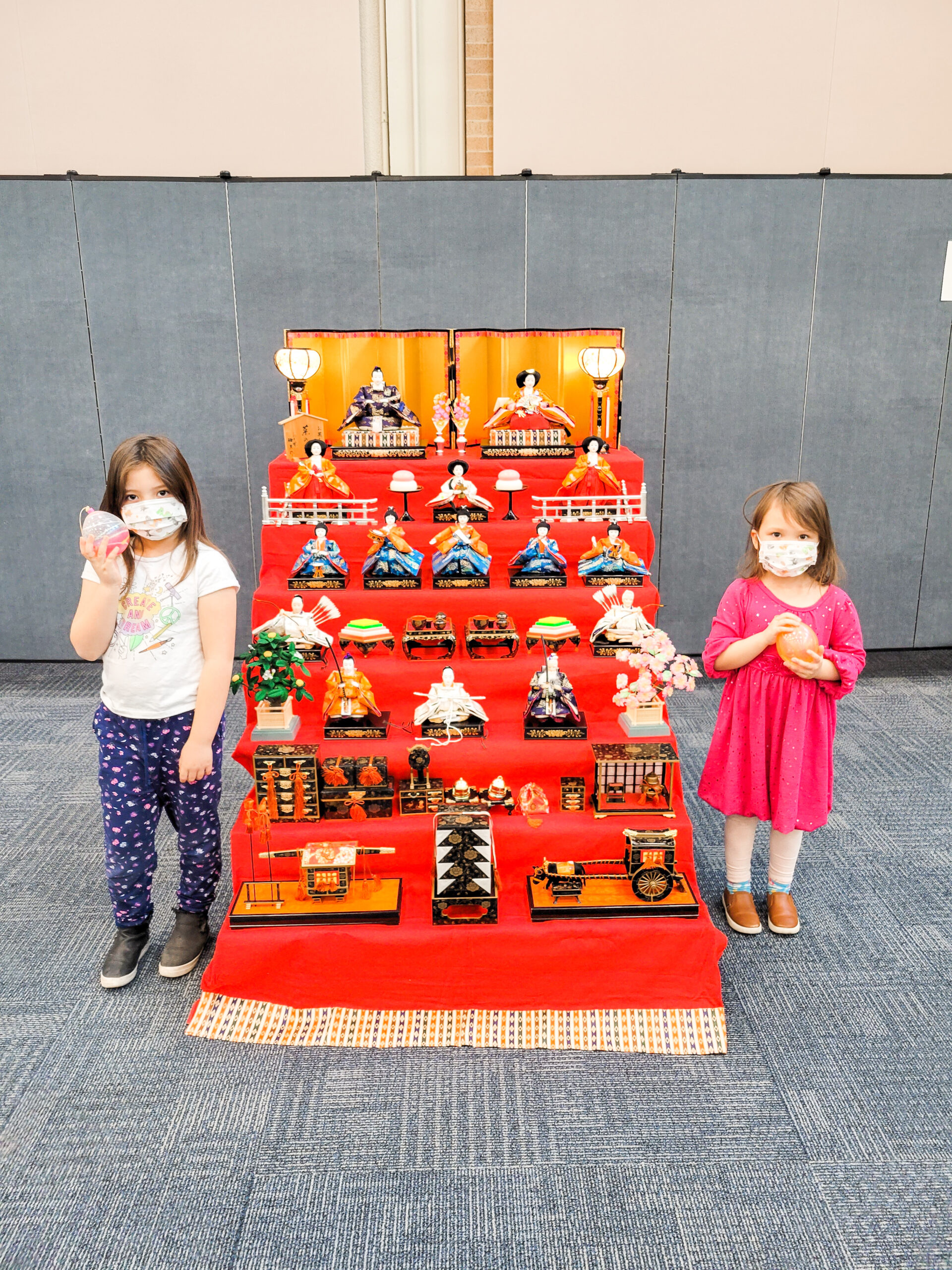 Momo's daughters next to traditional Hina doll set 